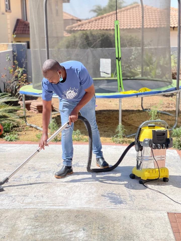 Fresh Lavation technician vacuuming carpet outdoors – Pretoria